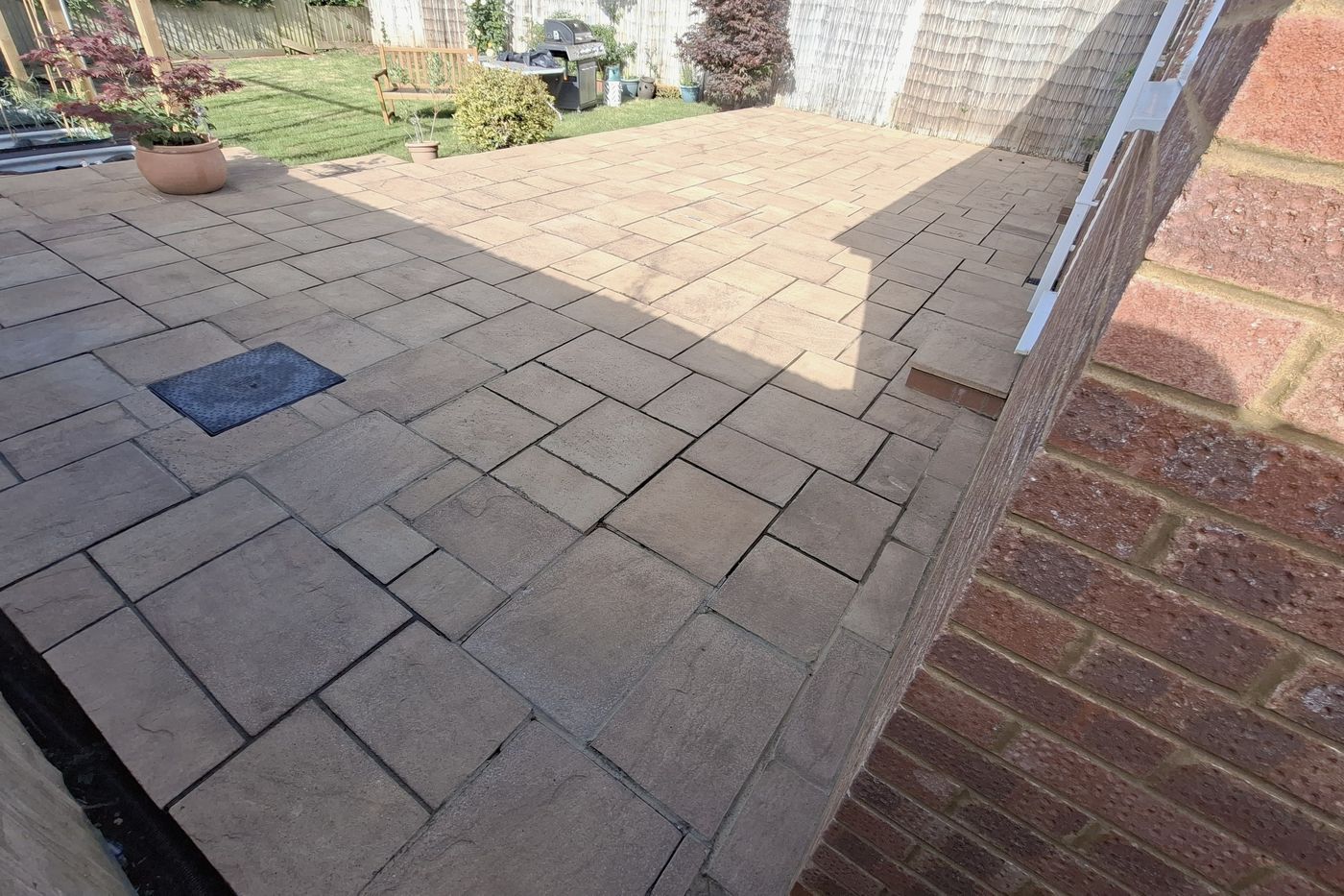 The same patio after pressure washing, with the stone colour restored